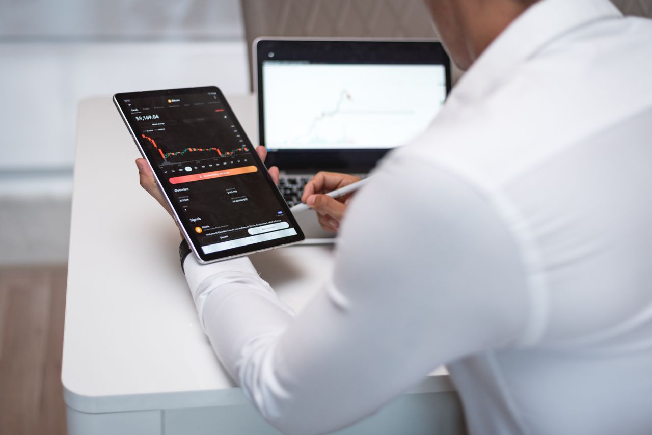 Professional analyzing financial ledger. Photo by AlphaTradeZone on Pexels